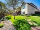 Expansive backyard with mature trees, stone walkway, and covered patio, a private outdoor retreat at 6266 W Prentice Ave, Littleton, CO 80123