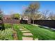 Enjoy lush backyard with manicured lawn, stone pathway, and privacy fence, an ideal setting for outdoor activities at 6266 W Prentice Ave, Littleton, CO 80123