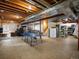 Unfinished basement with a ping pong table offers potential for customization and recreation at 6266 W Prentice Ave, Littleton, CO 80123