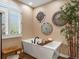 Modern tub with a bamboo accent, window and natural light create a tranquil atmosphere at 6266 W Prentice Ave, Littleton, CO 80123