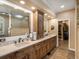 Spacious bathroom with dual sinks, a walk-in shower, and access to a walk-in closet at 6266 W Prentice Ave, Littleton, CO 80123
