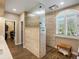 Spacious bathroom boasts a tiled walk-in shower with glass divider and a wood bench at 6266 W Prentice Ave, Littleton, CO 80123
