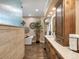 Well-lit bathroom with separate tub, walk-in shower, and and sinks at 6266 W Prentice Ave, Littleton, CO 80123
