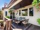 Enjoy outdoor dining on this covered patio with ceiling fan and glass table, a perfect spot for entertaining at 6266 W Prentice Ave, Littleton, CO 80123