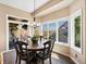 Bright dining room features a round table, large windows and access to a patio at 6266 W Prentice Ave, Littleton, CO 80123