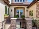 Inviting entryway featuring stone pillars, manicured foliage, and a decorative glass door at 6266 W Prentice Ave, Littleton, CO 80123