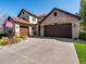 A charming home with a three-car garage, a manicured lawn, and an American flag in a flower-filled window box at 6266 W Prentice Ave, Littleton, CO 80123