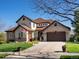 Charming two-story home featuring a stone-accented facade, three-car garage, and a well-manicured lawn at 6266 W Prentice Ave, Littleton, CO 80123