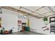 Spacious garage with high ceilings, storage racks, and well-organized lawn equipment creates an efficient work space at 6266 W Prentice Ave, Littleton, CO 80123
