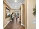 Inviting hallway features wood floors, neutral paint, and a mirror leading to the living spaces at 6266 W Prentice Ave, Littleton, CO 80123
