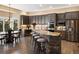 Stylish kitchen features granite counters, gray cabinets, bar seating, and stainless steel appliances at 6266 W Prentice Ave, Littleton, CO 80123