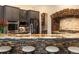 Kitchen bar with granite countertop, seating, stacked stone, and stainless steel appliances at 6266 W Prentice Ave, Littleton, CO 80123