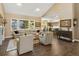 Open-concept living room with soaring ceilings, large windows, and seamless flow to the kitchen at 6266 W Prentice Ave, Littleton, CO 80123