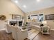 Cozy living room with a fireplace, large windows, vaulted ceiling, and comfortable seating at 6266 W Prentice Ave, Littleton, CO 80123