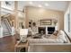 Bright living room with vaulted ceiling, fireplace, staircase, and an open layout at 6266 W Prentice Ave, Littleton, CO 80123