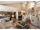 Spacious living room featuring an open layout, fireplace, staircase, and kitchen views at 6266 W Prentice Ave, Littleton, CO 80123