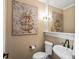 Elegant powder room featuring a decorative mirror and stylish floral artwork at 6266 W Prentice Ave, Littleton, CO 80123
