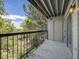 Balcony overlooking leafy tree tops and sky with clouds at 2575 S Syracuse Way # K201, Denver, CO 80231