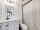 Updated bathroom featuring a white vanity, decorative mirror, and stylish shower curtain at 2575 S Syracuse Way # K201, Denver, CO 80231