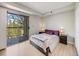 Bright bedroom with sliding glass door access to balcony featuring scenic outdoor views at 2575 S Syracuse Way # K201, Denver, CO 80231