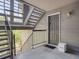 Exterior entryway of unit 201 featuring stairs, dark door, and Riddwell box at 2575 S Syracuse Way # K201, Denver, CO 80231