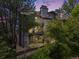 Multi-story condominium building with stone and siding exterior and balconies surrounded by lush landscaping at 2575 S Syracuse Way # K201, Denver, CO 80231