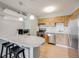 Kitchen featuring stainless steel appliances, counter seating, and wood cabinetry at 2575 S Syracuse Way # K201, Denver, CO 80231