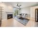 Cozy living room featuring a fireplace, modern furnishings, and balcony access at 2575 S Syracuse Way # K201, Denver, CO 80231