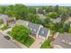 Aerial view of a two-story home with mature trees, manicured lawns, and a basketball hoop in the driveway at 6839 S Niagara Ct, Centennial, CO 80112
