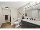 Modern bathroom featuring a black vanity, marble countertop, updated fixtures, and a shower at 6839 S Niagara Ct, Centennial, CO 80112