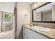 Bathroom featuring a granite vanity, shower with tile surround, and a view into a secondary area at 6839 S Niagara Ct, Centennial, CO 80112