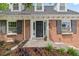 Close-up of the brick home's front door entrance with flower boxes and landscaping at 6839 S Niagara Ct, Centennial, CO 80112