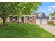 Lovely brick home with manicured lawn and a mature tree in the front yard at 6839 S Niagara Ct, Centennial, CO 80112