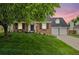 Beautiful brick home with a well-manicured lawn and mature shade tree at 6839 S Niagara Ct, Centennial, CO 80112
