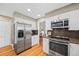 Spacious kitchen features stainless steel refrigerator and modern appliances, and hardwood floors at 6839 S Niagara Ct, Centennial, CO 80112