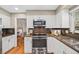 Updated kitchen showcasing modern stainless steel appliances, granite counters, and ample cabinet space at 6839 S Niagara Ct, Centennial, CO 80112