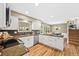 Bright kitchen featuring granite countertops, stainless steel appliances, and beautiful hardwood floors at 6839 S Niagara Ct, Centennial, CO 80112