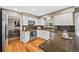 Well-appointed kitchen with white cabinetry, granite countertops, and stainless steel appliances at 6839 S Niagara Ct, Centennial, CO 80112