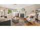 Cozy living room featuring a fireplace, hardwood floors, and large window at 6839 S Niagara Ct, Centennial, CO 80112