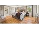 Serene main bedroom with hardwood floors, large windows, and neutral decor at 6839 S Niagara Ct, Centennial, CO 80112