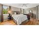Relaxing main bedroom featuring hardwood floors, and large windows with natural light at 6839 S Niagara Ct, Centennial, CO 80112