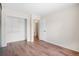 A bedroom with wood laminate flooring, closet and white walls offers an open space at 6318 Newton Ct, Arvada, CO 80003