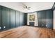 Inviting bedroom featuring hardwood floors, large window and paneled walls at 6318 Newton Ct, Arvada, CO 80003