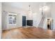 Welcoming entryway featuring hardwood floors, a bright window, and a modern staircase leading to the upper level at 6318 Newton Ct, Arvada, CO 80003