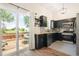 Modern kitchen featuring stainless steel appliances, granite counters, and sliding doors to the deck at 6318 Newton Ct, Arvada, CO 80003
