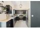 Well-lit kitchen featuring granite counters, stainless steel appliances, and a stylish pendant light at 6318 Newton Ct, Arvada, CO 80003