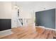 Spacious living room with hardwood floors, a modern staircase, and a beautiful accent wall, great for entertaining at 6318 Newton Ct, Arvada, CO 80003