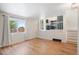 Bright living room featuring hardwood floors, neutral walls, and an open floor plan at 6318 Newton Ct, Arvada, CO 80003