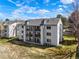 Exterior view of a three-story condo building with black metal balcony railings at 13093 W Cedar Dr # 322, Lakewood, CO 80228