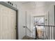 Hallway view of a door to an apartment, a staircase and a window overlooking the parking lot at 13093 W Cedar Dr # 322, Lakewood, CO 80228